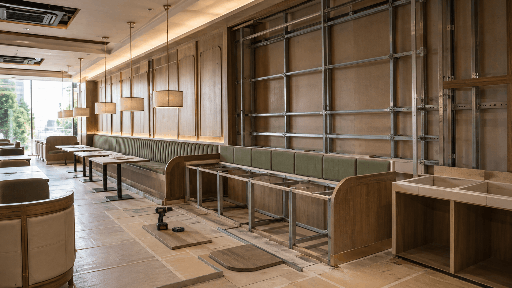 Restaurant under construction with banquette seating and wall panelling frames being installed on site
